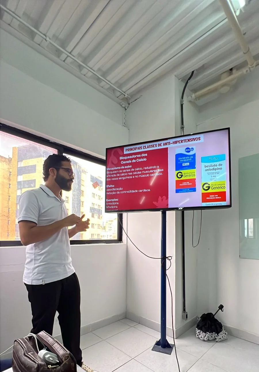 Daniel P Francisco presenting a seminar in a classroom, with a slide on the screen beside him