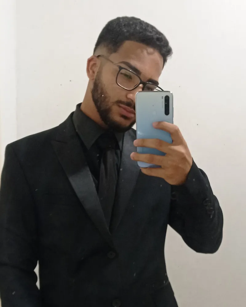 Daniel P Francisco in a black suit, in a mirror photo